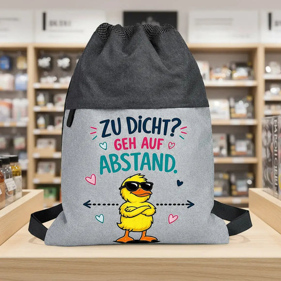 Grauer Sportbeutel mit Cartoon-Ente und modernem buntem Schriftzug für Jugendliche.