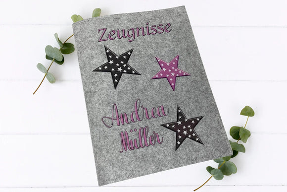 Handgefertigte Zeugnismappen mit auffälligem Sternenmotiv in rosa und weiß – auf Filz in zwei Farbtönen