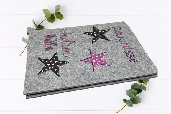 Zeugnismappe mit stilvollen Sternen in Kontrastfarben – personalisiert mit Namen, ideal zur Einschulung