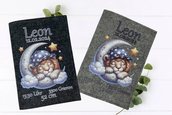 ustrative U-Heft-Hülle aus Filz mit Löwenbaby in Schlafmütze auf einer Mondsichel.