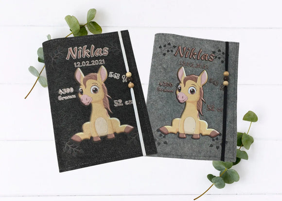 U-Heft-Hülle mit niedlichem Comic-Pferd in Beige und Braun, schwarzem Gummiband und Holzperlen.