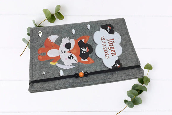 U-Heft-Hülle mit frechem Fuchs im Seeräuber-Stil, verziert mit orange-schwarz-weißen Holzperlen.