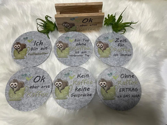 Schwarzer Filzuntersetzer mit niedlichem Faultier und der Aufschrift „Vor dem Kaffee keine Antwort“