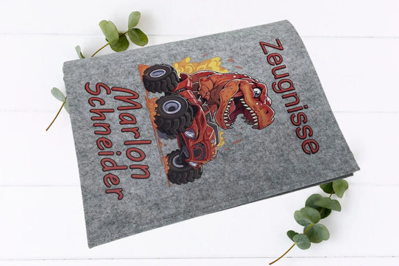 Kinder-Zeugnismappen aus Filz mit verspieltem Dino-Motiv und rotem Schriftzug „Zeugnisse“ sowie Namensaufdruck.