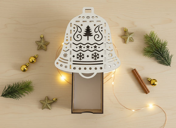 Geschenkschachtel Glocke mit goldener Weihnachtsdeko und warmem Licht
